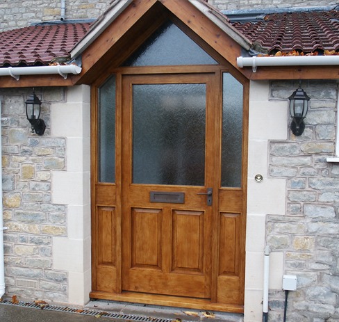 Hardwood glazed front door inside a timber porch