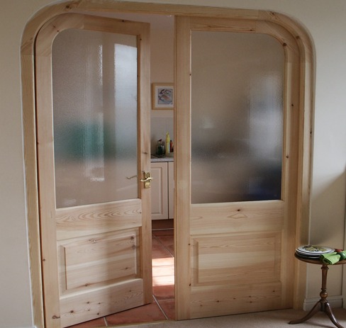 Pine glazed internal double doors with panelled lower halves