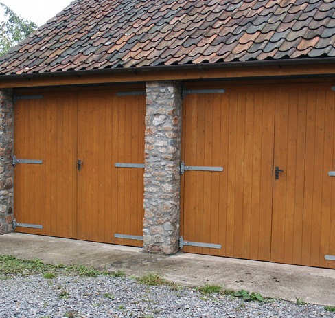 Pair of oak garage doors on a stone outbuilding