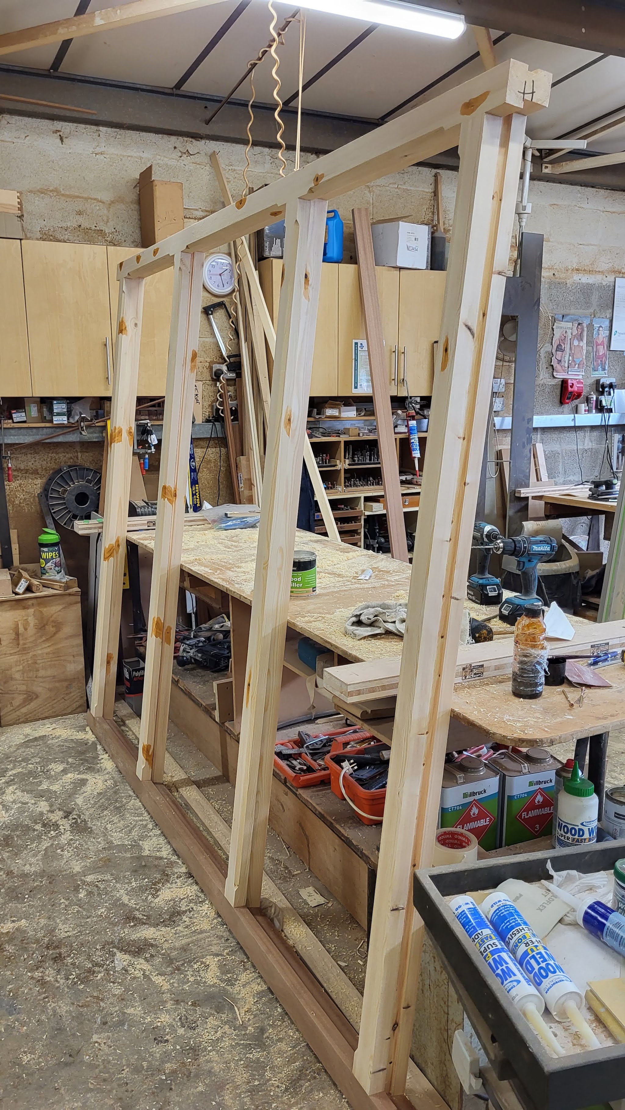 A tall timber frame being made at a bench in our workshop