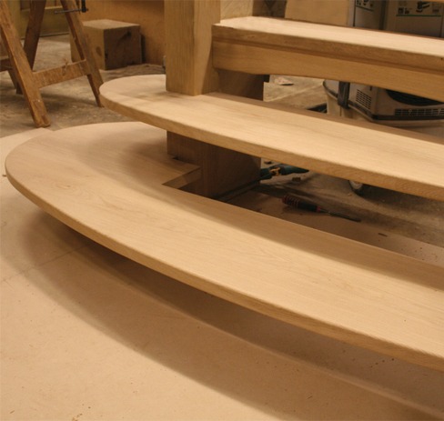 Oak staircase with a curved bottom step in our workshop