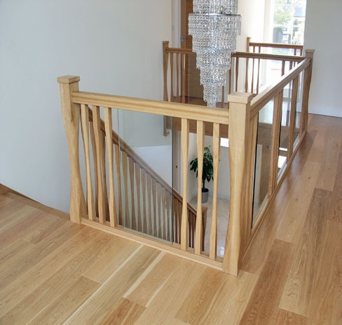 Oak balustrade around a stairwell on a light oak floor