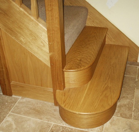 Rounded oak bottom steps on an oak staircase