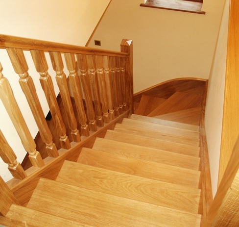 Oak staircase seen from the landing with turned spindles